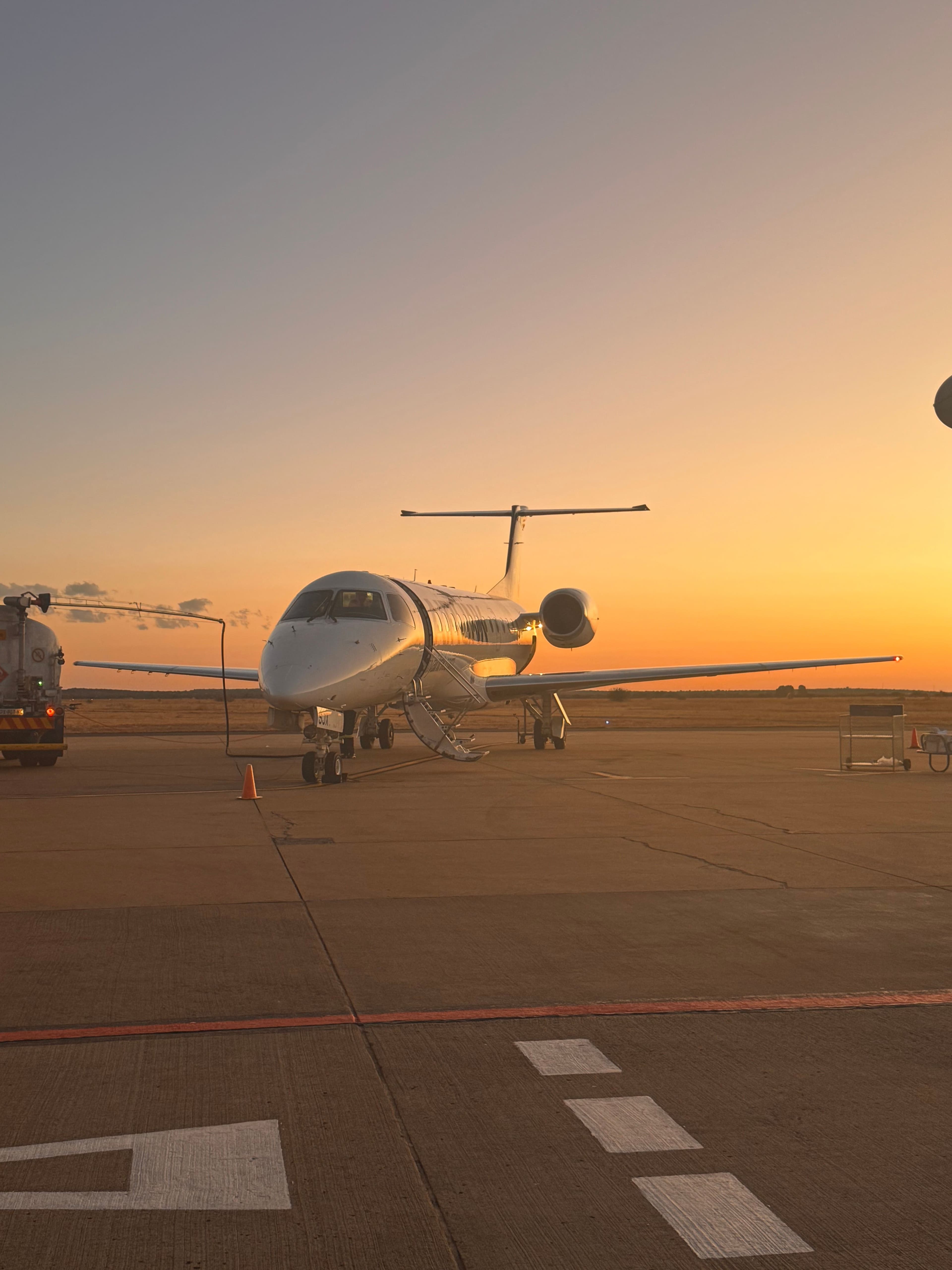 Private jet on the ramp at sunset — Altitude Dining